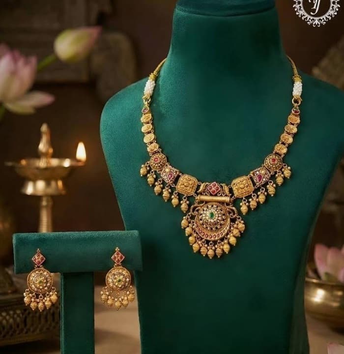 Tulsi Jewellers: Royal bridal gold choker necklace with uncut Polki diamonds and Zambian emerald drops on deep crimson velvet